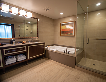Bathroom in at Osage Casino Hotel Tulsa suite with separate bath and shower.