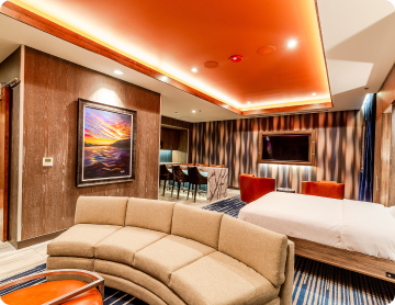 A hotel room at Osage Casino Hotel Tulsa with a curved couch in foreground